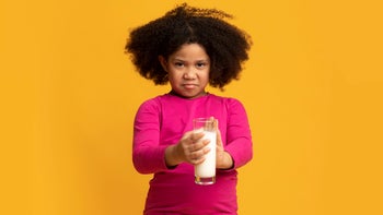 Health: Digestive: young girl disgust face holding milk glass 1221347968