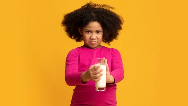 Health: Digestive: young girl disgust face holding milk glass 1221347968