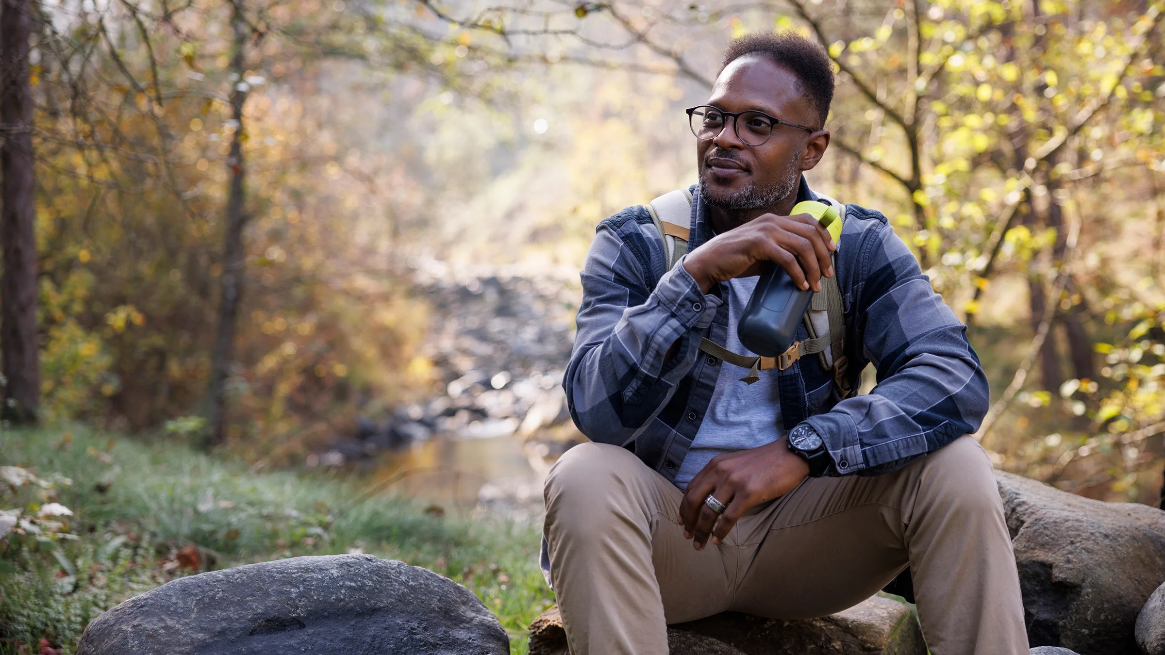 A man is relaxing in the forest.