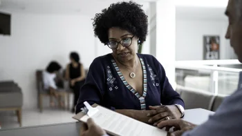 Benlysta: woman talking to reception 1198824620