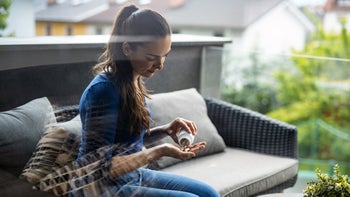 Health: Pamprin: woman pouring medicine in hand 1240570792
