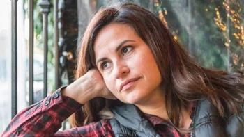 middle aged woman looking out window 1047378038