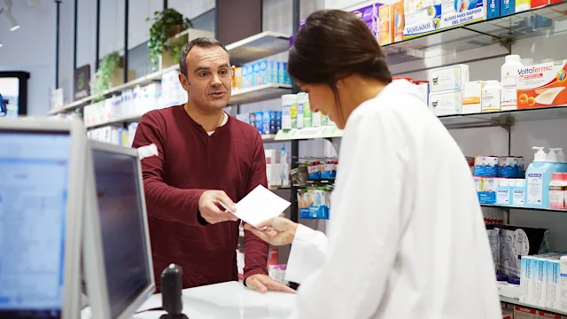 Health: Effexor: customer handing Rx to pharmacist 1280451296