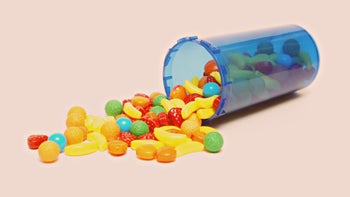 colorful candy spilling out of pill bottle 524921545