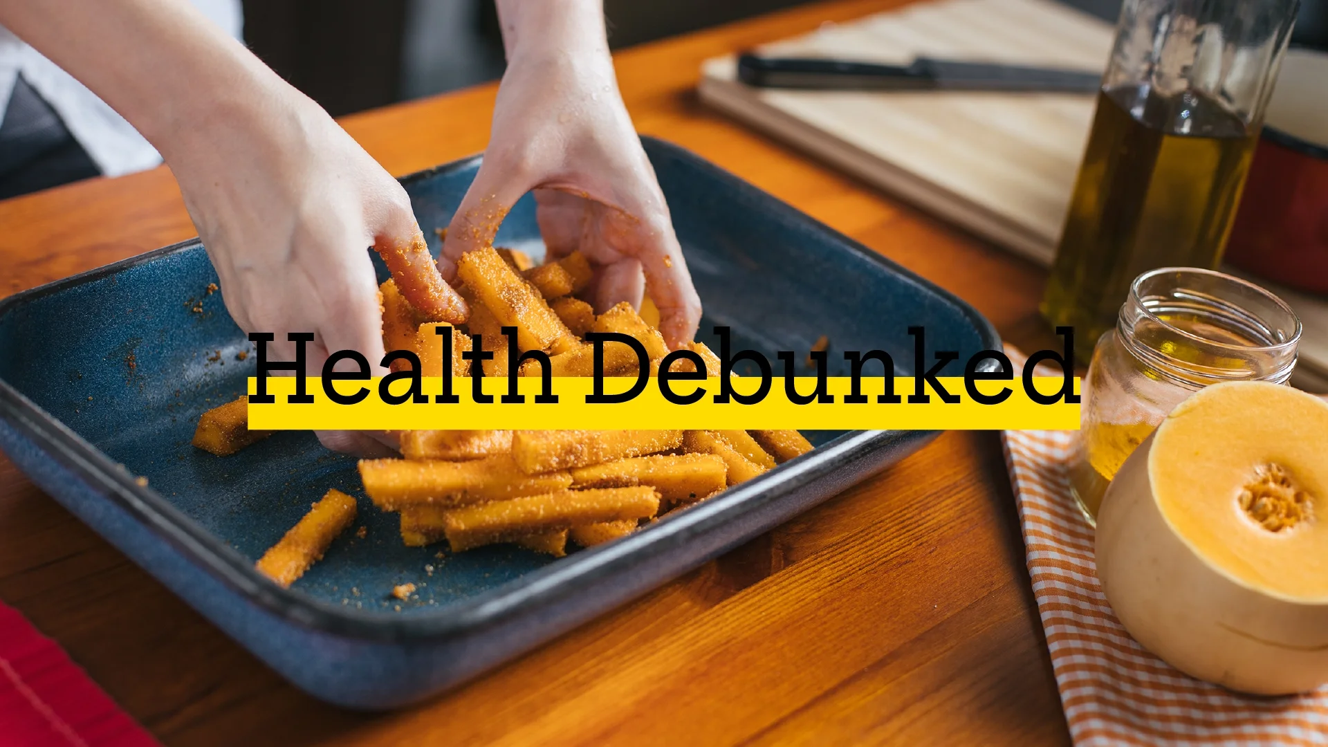 Person seasoning butternut squash fries on sheet pan. There is added text on top reading “Health Debunked” with a yellow highlight bar behind it.