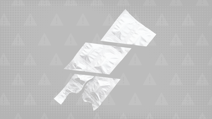 Dark gray background with texture and warning sign pattern. In the center is a foil package of pill opened up and cut into thirds. 