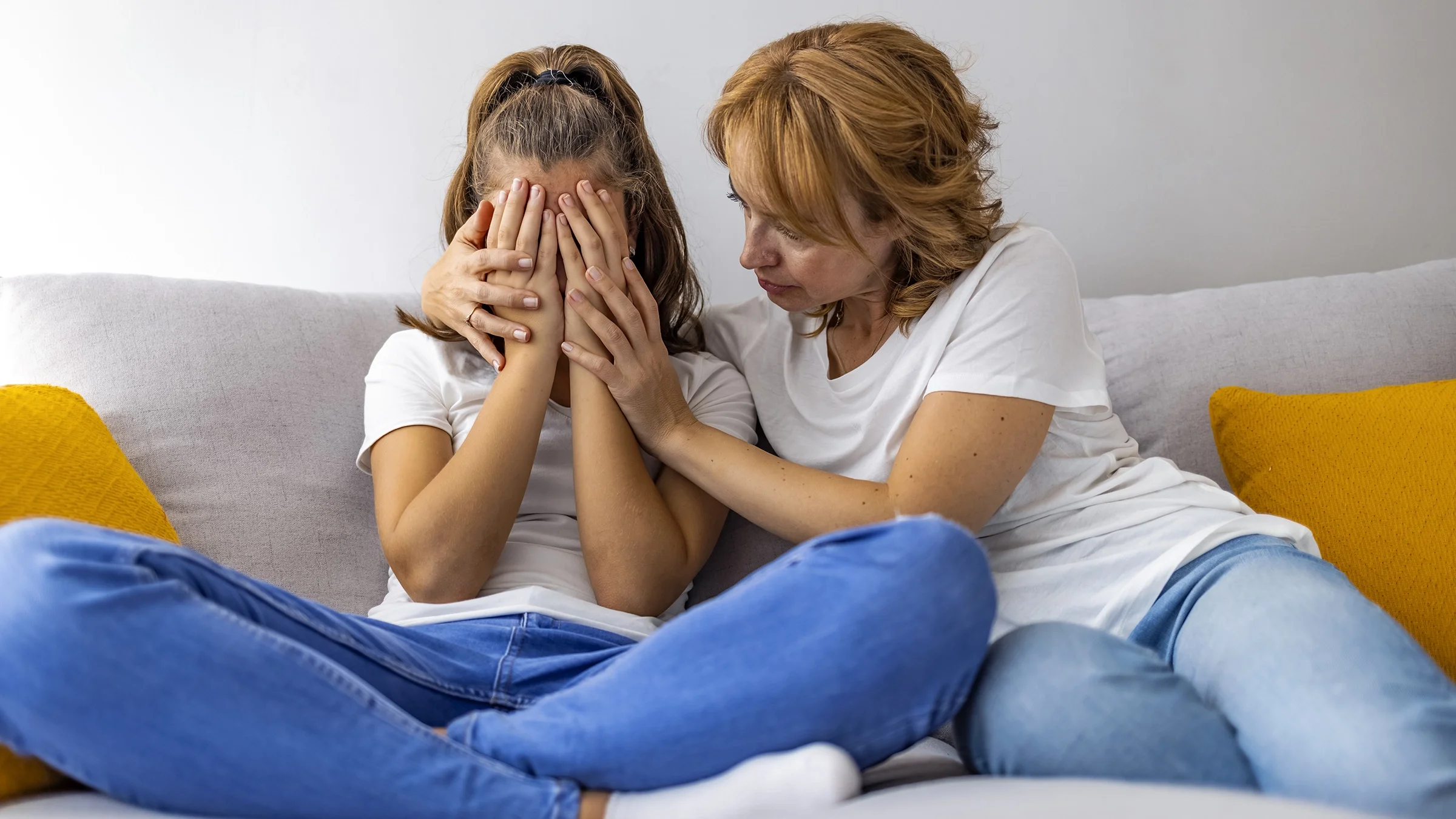 A mother is consoling her daughter.