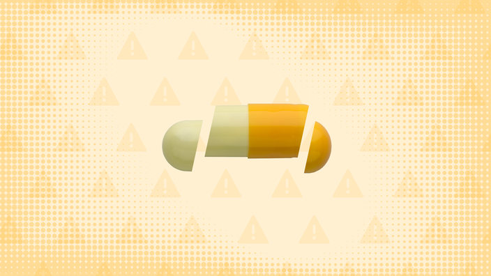 In the center of a light orange-yellow background with texture and warning sign pattern is a light yellow-and-orange capsule pill cut into thirds. 