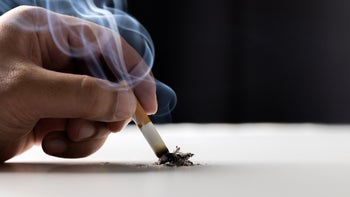 smoking-cessation: closeup putting out cigarette butt 1305966368