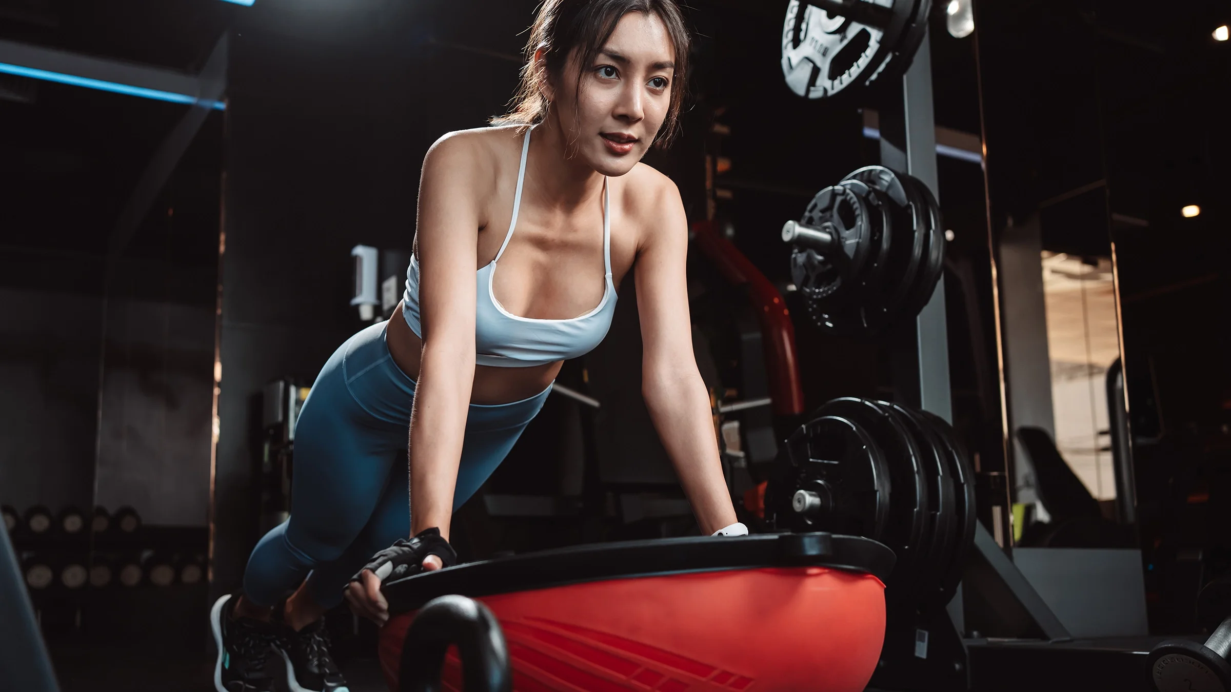 Woman doing plank exercise on BOSU ball.