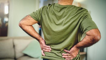 medication-education: back pain: lower back: cropped man rubbing lower back pain-1347841313
