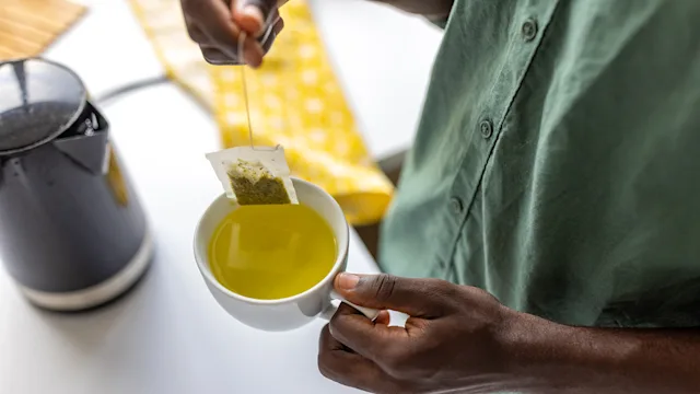 Gut-health: closeup making tea in mug 1496354928