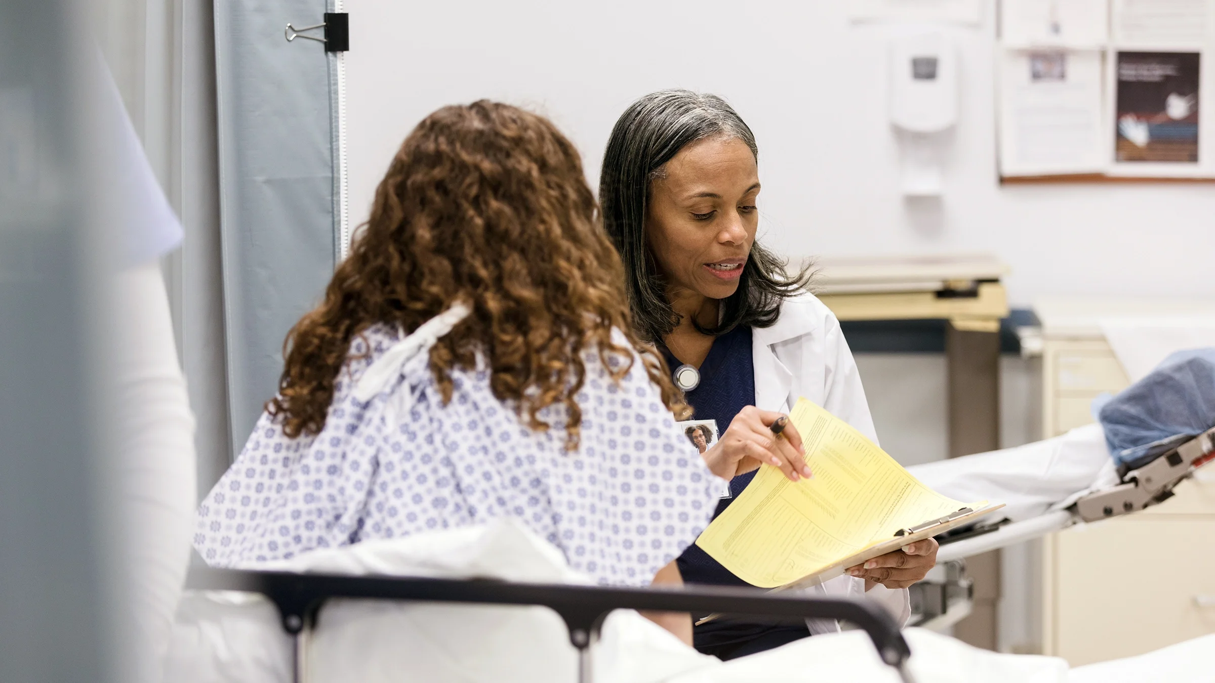 A doctor goes over test results with a patient.