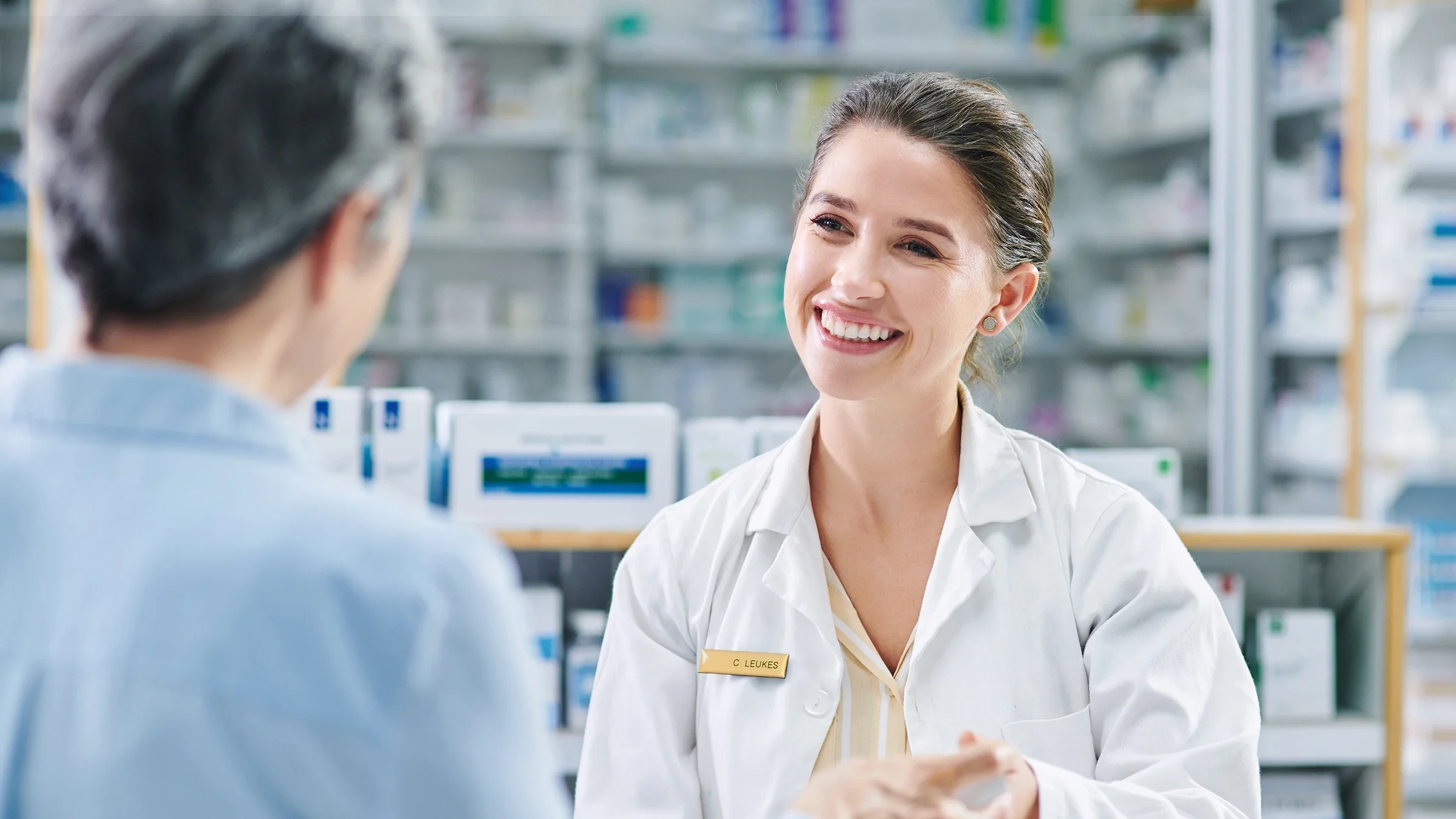 A pharmacist speaks to a customer.