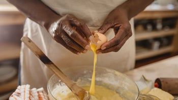 Health: Diet and nutrition: closeup woman cracking egg into bowl 1179997283