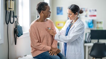 atrial fibrillation: doctor listening to patients heartbeat 1869998947