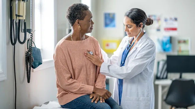 atrial fibrillation: doctor listening to patients heartbeat 1869998947