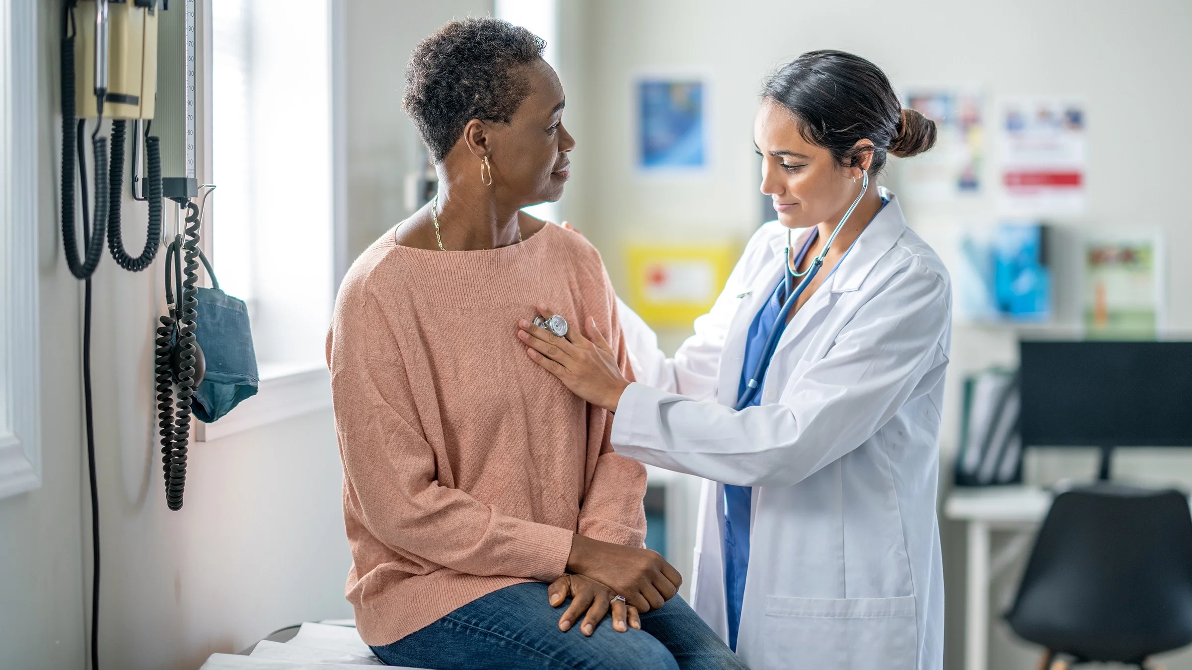 Doctor listens to a patient's heart.
