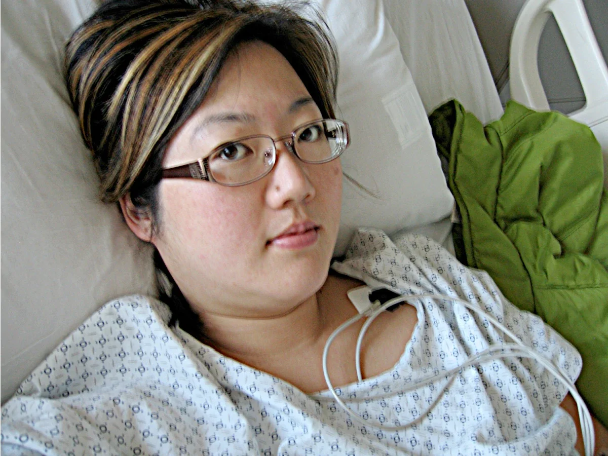 Christine H. Lee is pictured in a hospital bed.