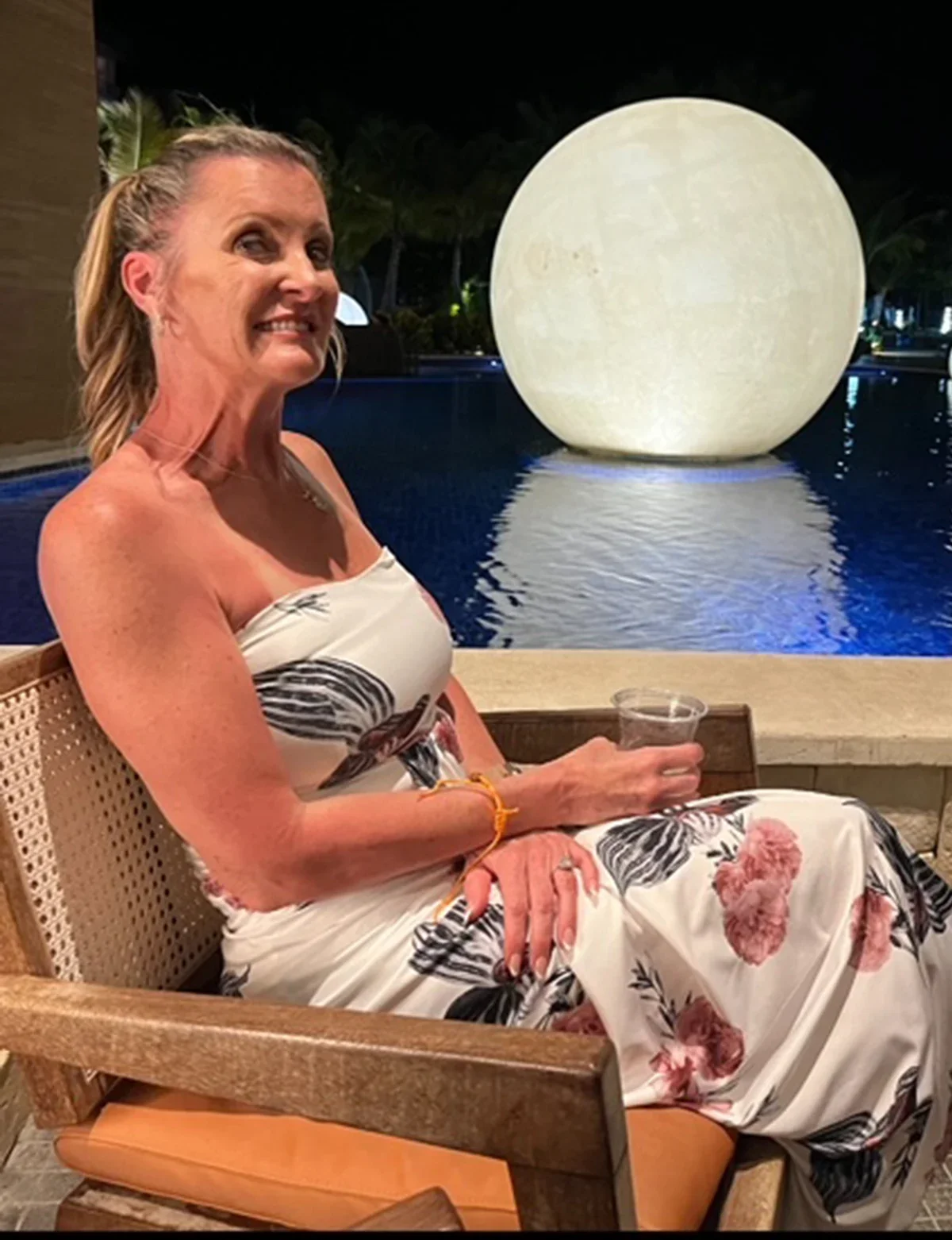 Shannon Townley is pictured sitting by a swimming pool.