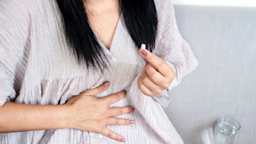 A woman is taking a pill for stomach pain.
Doucefleur/iStock via Getty Images Plus