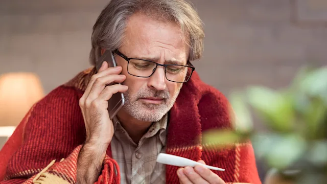 Fever: emergency room: sick holding thermometer phone call 903708662