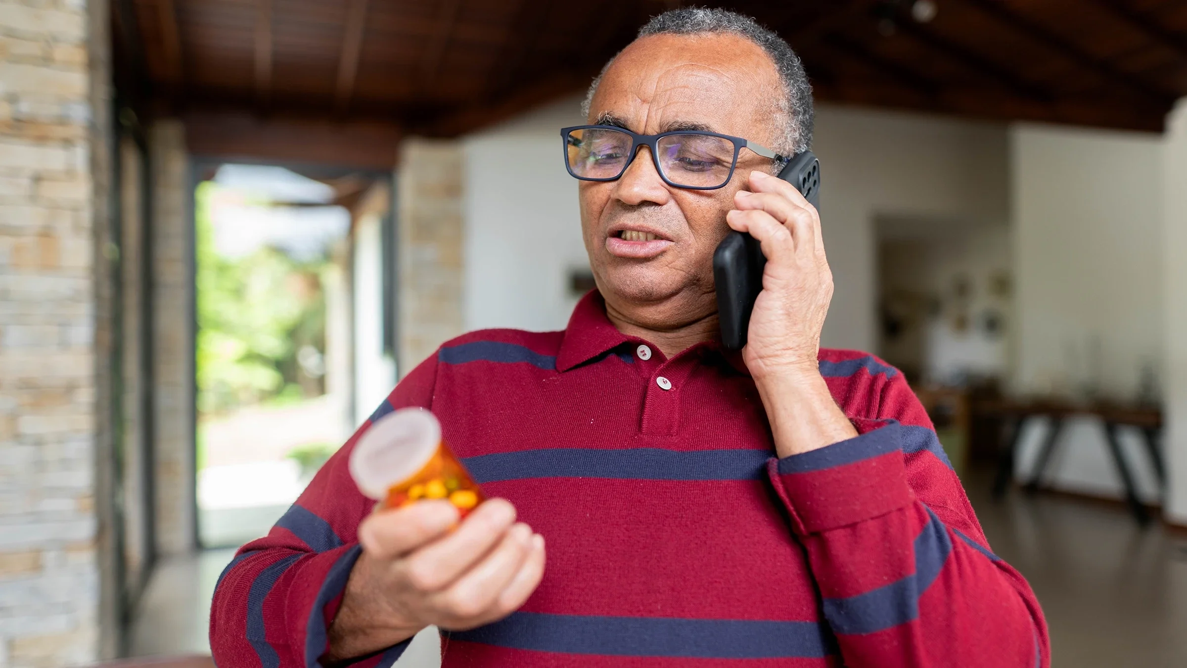 Senior man calling a pharmacy regarding his prescription medication