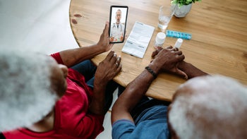 high-cholesterol: senior couple discuss medication during virtual appointment 1475832045