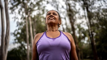 Health: Menopause: woman smiling in park 1415819479