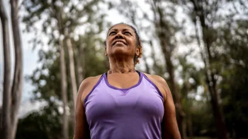 Health: Menopause: woman smiling in park 1415819479