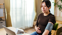 A pregnant woman is talking with her doctor on a video call while checking her blood pressure. 
recep-bg/E+ via Getty Images 
