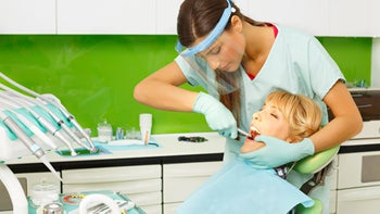 Health: Dental care: dentist extracting womans-tooth-467100386