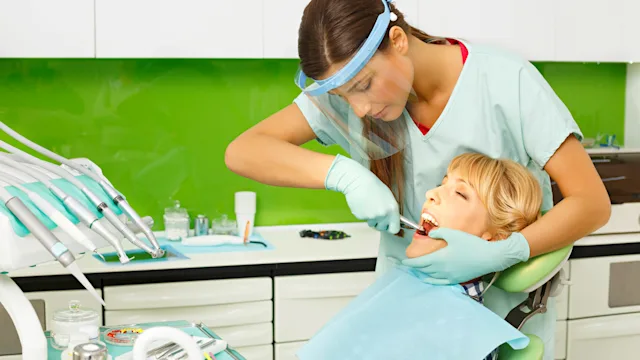 Health: Dental care: dentist extracting womans-tooth-467100386