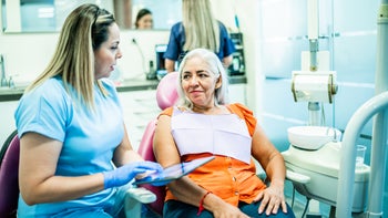 procedure: dentist discussing xray with patient 1512073945