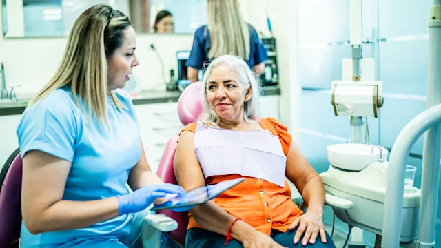 procedure: dentist discussing xray with patient 1512073945