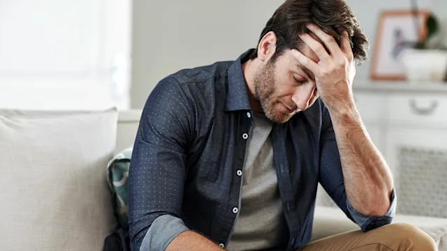 Mental Health: man upset on couch 1181530960