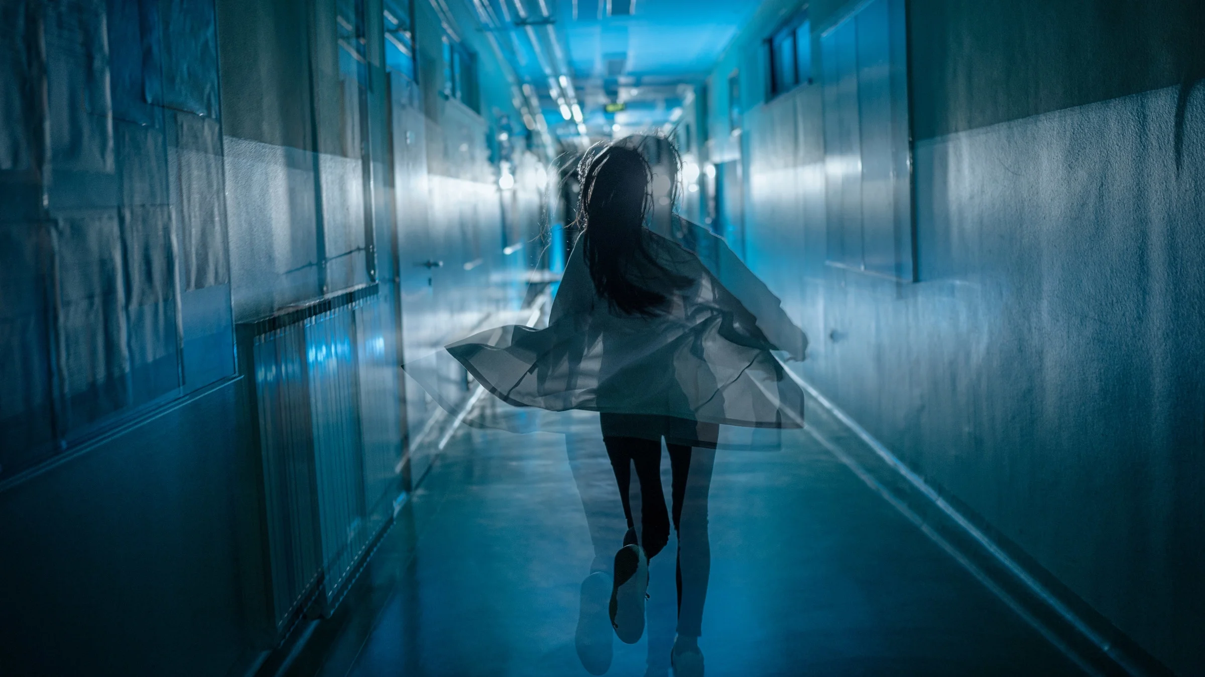 A person running down a corridor.