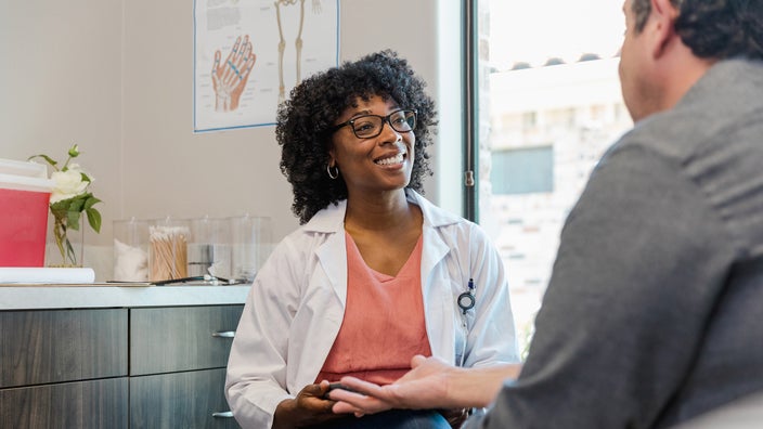 A healthcare professional speaks to a patient.