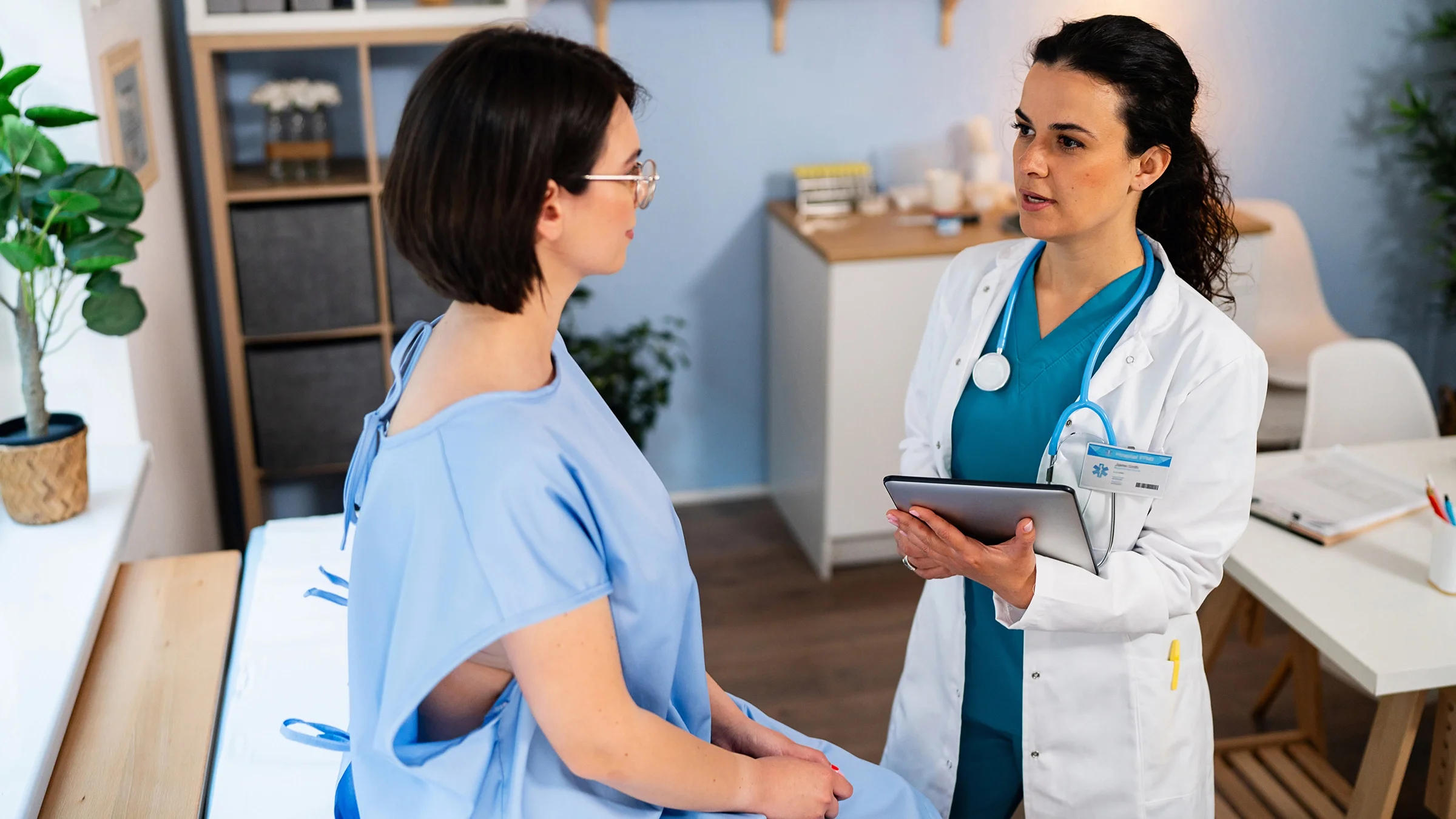 Patient at a medical checkup and wearing a hospital gown.