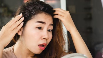 Hair: woman checking grey hair 1453882365