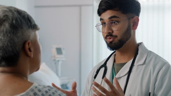 Research: medical professional speaking to a patient 2162083882