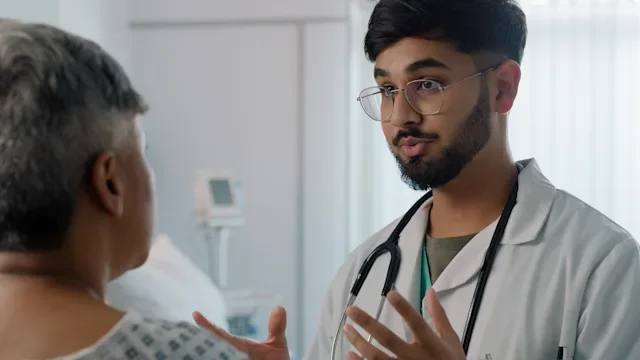 Research: medical professional speaking to a patient 2162083882