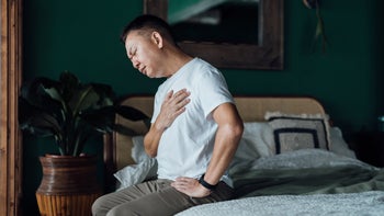 Health: Coronary Artery Disease: man getting out of bed with chest pain 1354565620