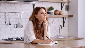 Diet and nutrition: woman writing in her notebook 1441831249
