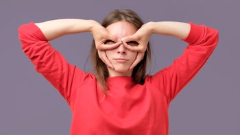 musculoskeletal: woman with fingers on face as mask 980763860