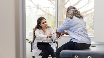 Gout: medical professional examining patients elbow 1482018562