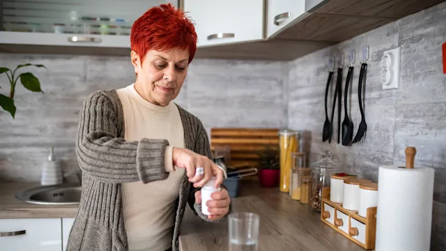 alendronate: senior woman taking medication 1972099255