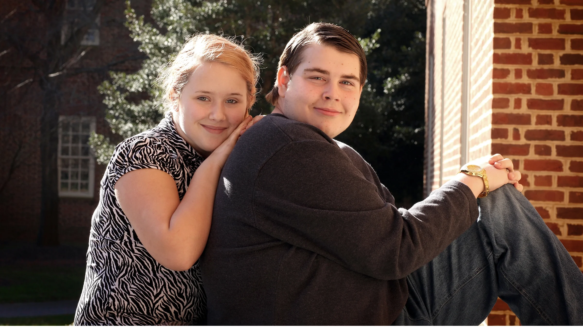 Couple posing for a portrait outdoors.