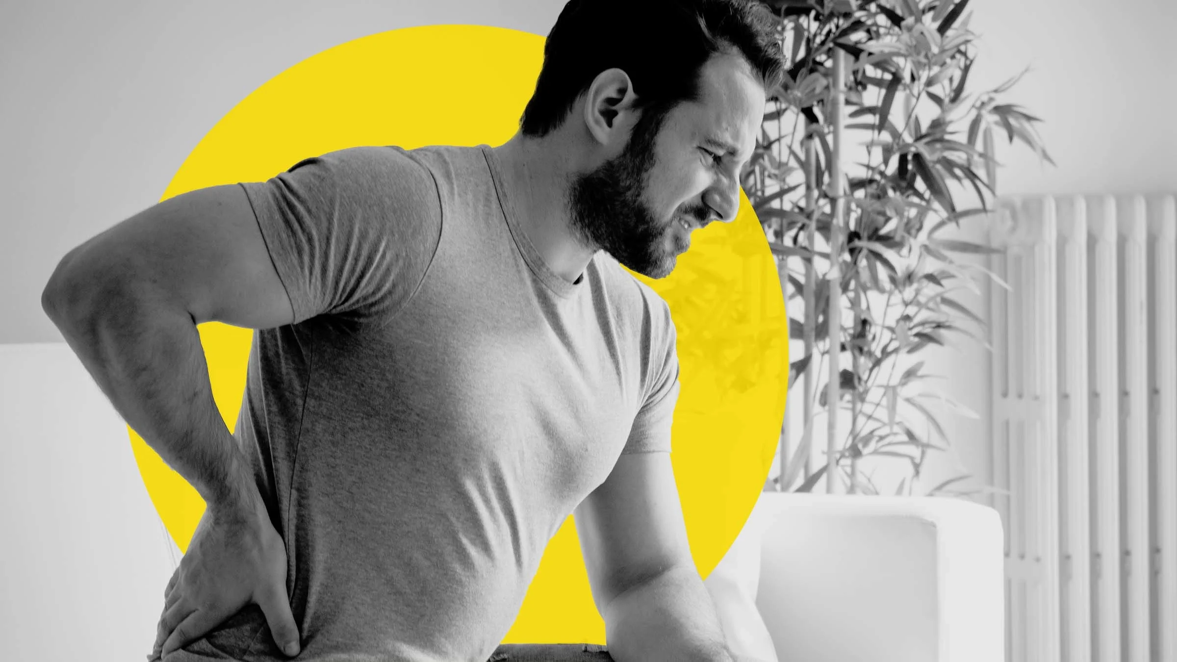 Black and white image of a man bent over with kidney stone pain. There is an added yellow graphic circle behind him.