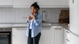 A person taking a pill in their kitchen.
Dima Berlin/iStock via Getty Images Plus 